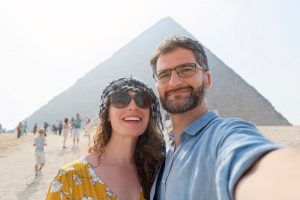 Best time to visit Egypt - Traveling couple taking selfie while visiting Pyramids of Giza in Egypt.-Egypt Tours Packages From USA