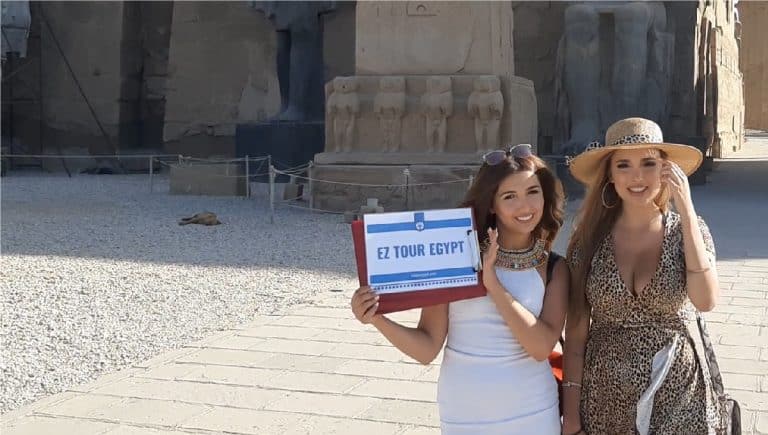 Egypt packages - Two beautiful girls holding EZ TOUR EGYPT - sign