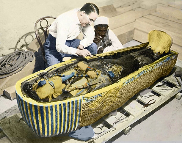 British archaeologist Howard Carter with one of his workers examined Tutankhamun's golden coffin