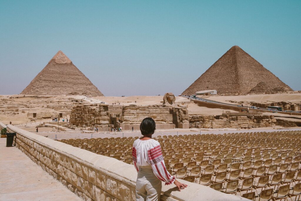 woman standing in front of the pyramids of Giza - Egypt day tour