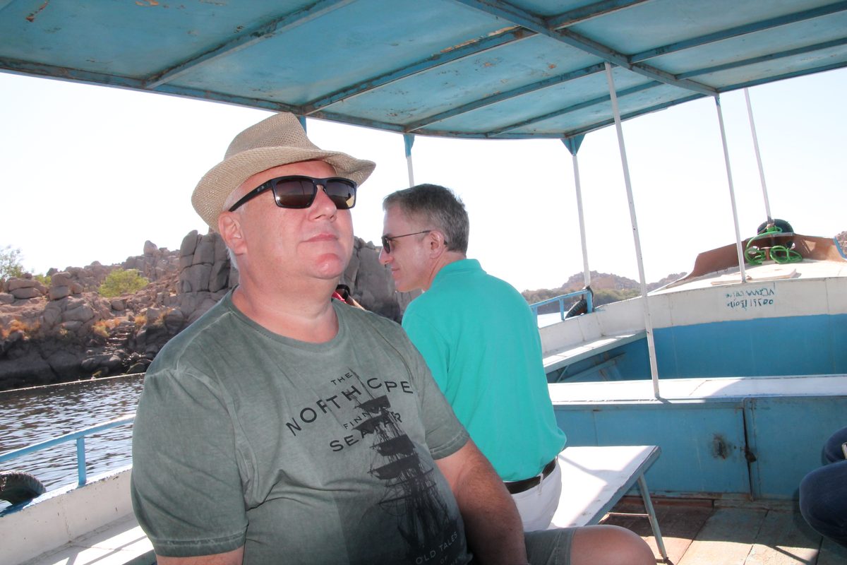 Don't Take Our Word For It - 12 - EZ TOUR EGYPT Two travellers relaxing under the canopy of a private Nile boat passing the granite islands near Aswan
